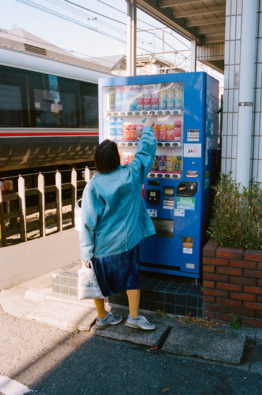 Mayumi wearing vowels Chore Jacket in Bleached Indigo